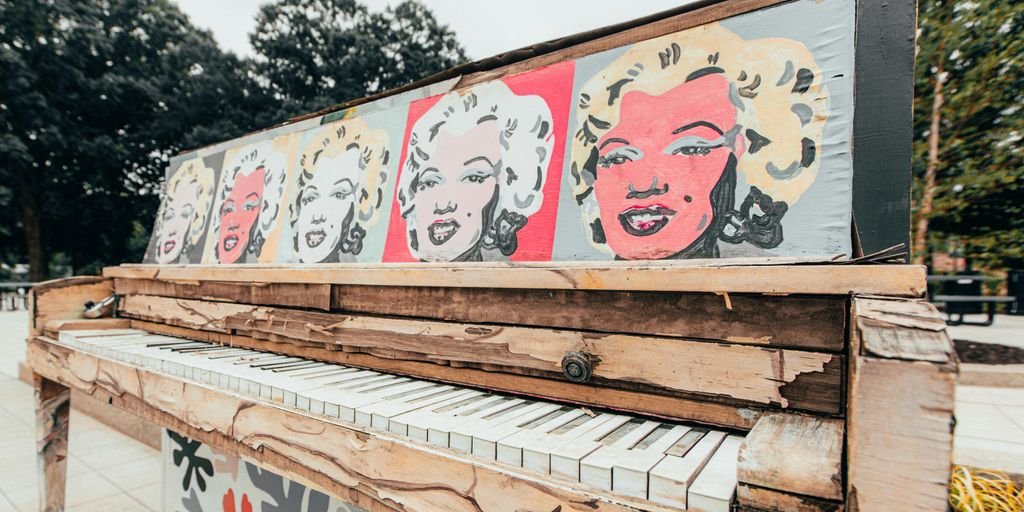 white and red graffiti on brown wooden fence