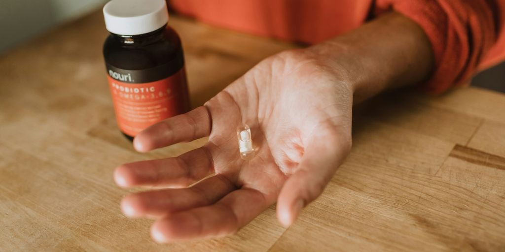 person holding medication pill