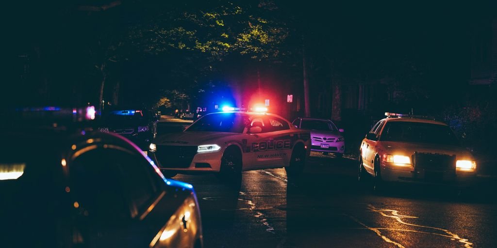 A couple of police cars parked in a parking lot