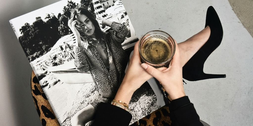 woman holding clear glass candle holder and grayscale portrait of a woman